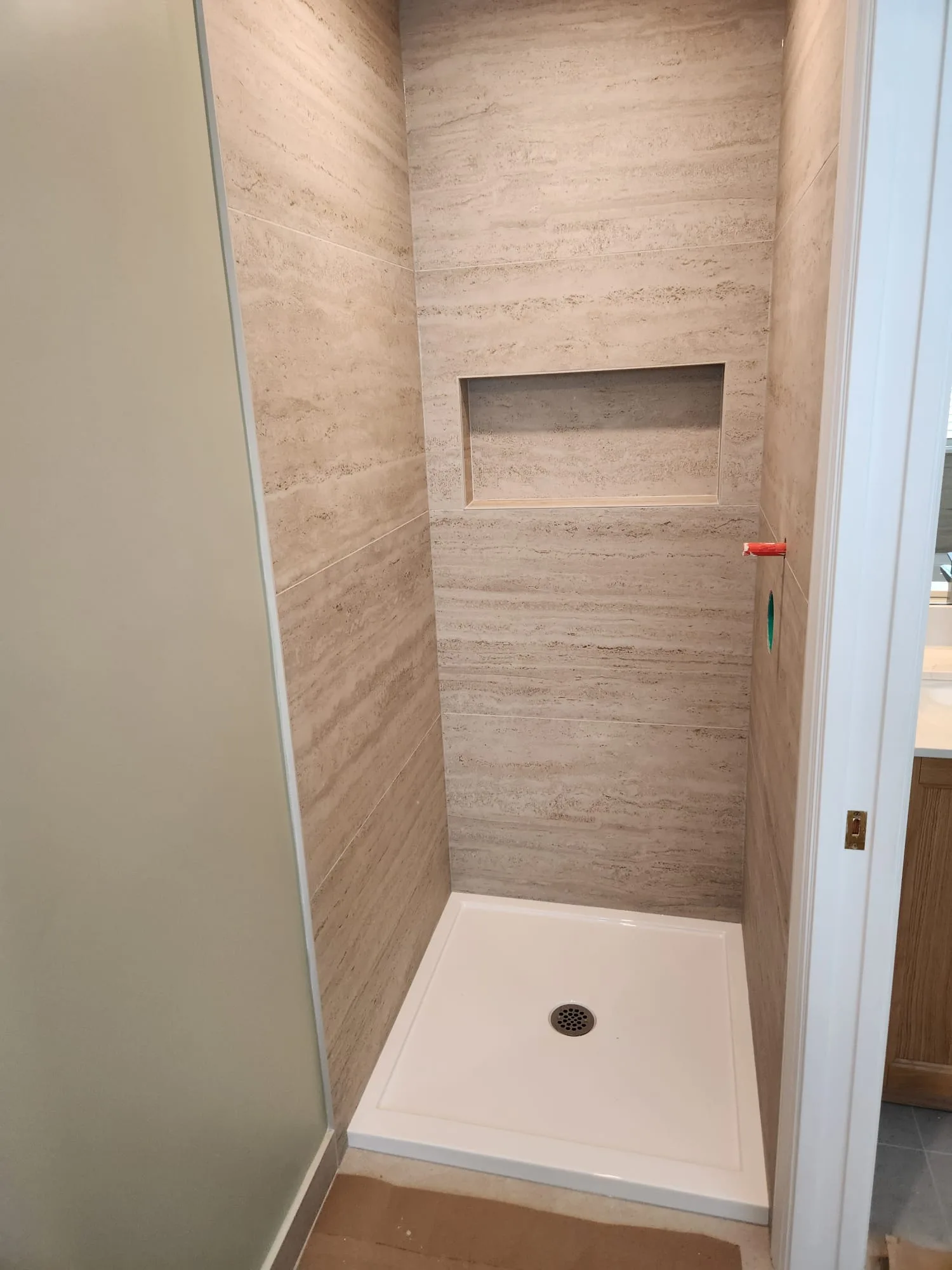 Before installation — alternate angle of tile niche showing recessed shelf and shower base